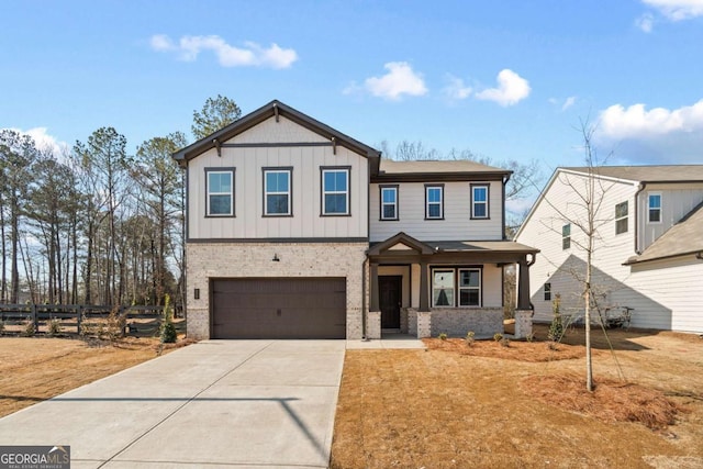 view of front facade featuring concrete driveway, an attached garage, fence, board and batten siding, and brick siding