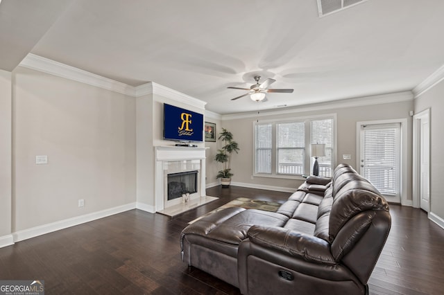 living room featuring dark wood-style floors, a premium fireplace, visible vents, and crown molding