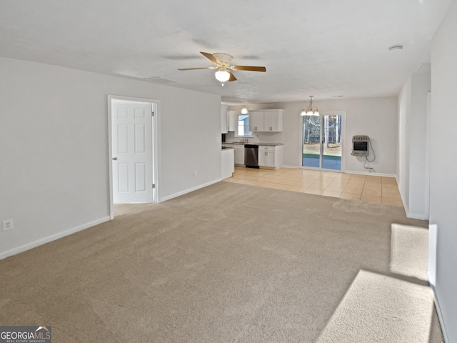 unfurnished living room featuring light tile patterned floors, baseboards, light colored carpet, heating unit, and ceiling fan with notable chandelier