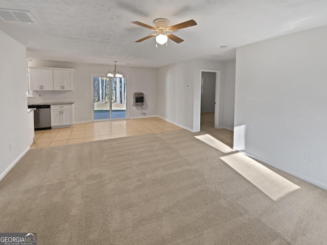 unfurnished living room featuring light colored carpet, visible vents, heating unit, and light tile patterned flooring