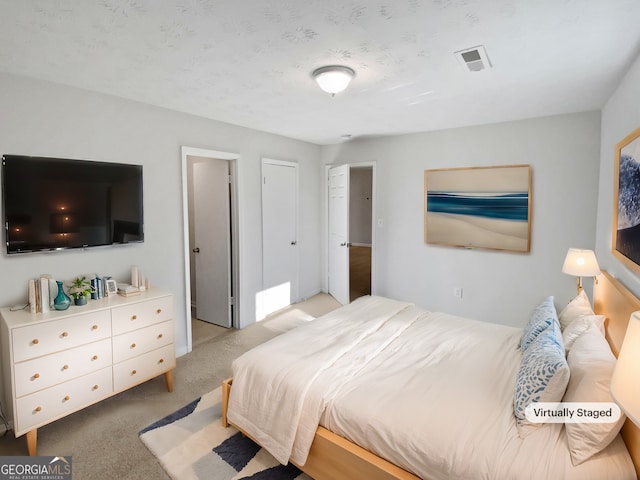 bedroom featuring light carpet and visible vents