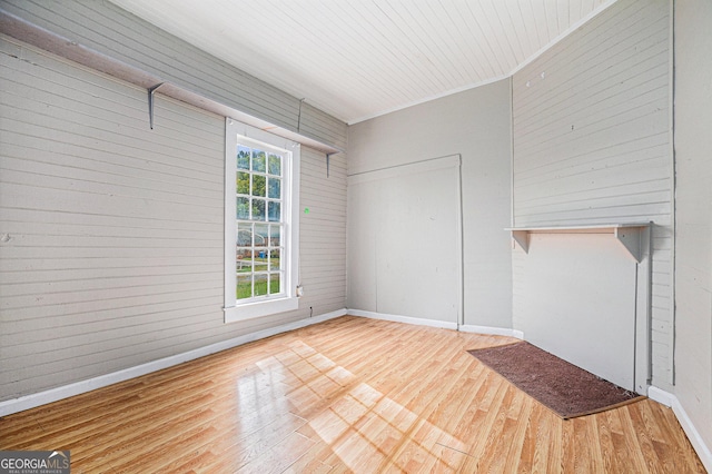 interior space featuring wooden ceiling, wood finished floors, and baseboards