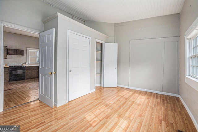 unfurnished bedroom featuring light wood-style flooring