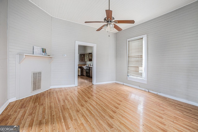 unfurnished living room with visible vents, a fireplace, light wood-style flooring, and ceiling fan