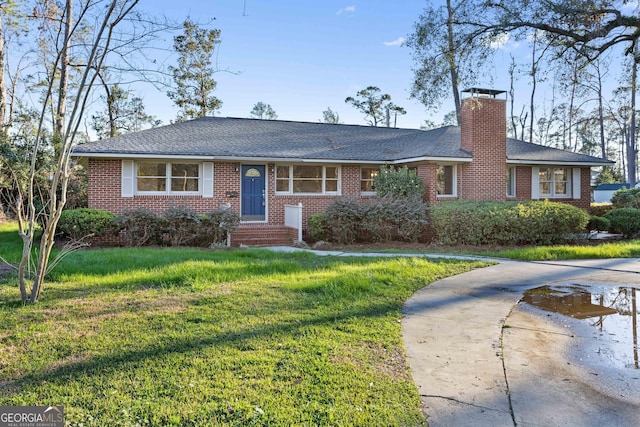 ranch-style house featuring concrete driveway, brick siding, a chimney, and a front yard