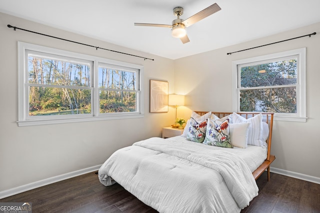 bedroom with ceiling fan, multiple windows, dark wood finished floors, and baseboards