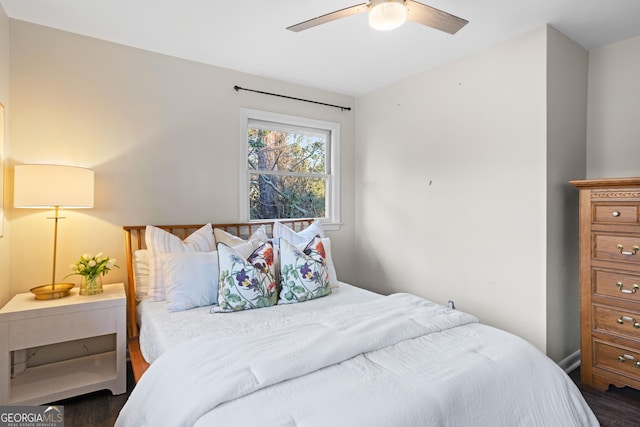 bedroom featuring dark wood-type flooring and a ceiling fan