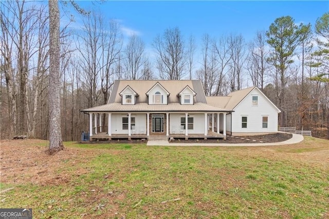 farmhouse with a porch and a front lawn