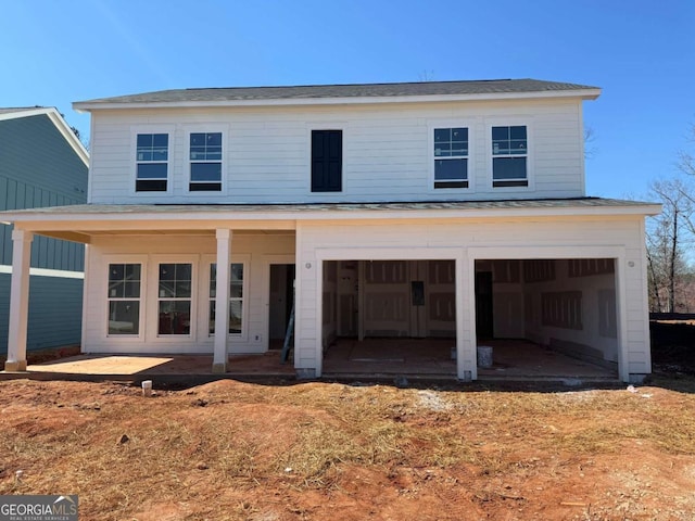 view of front of property featuring a garage and a patio area