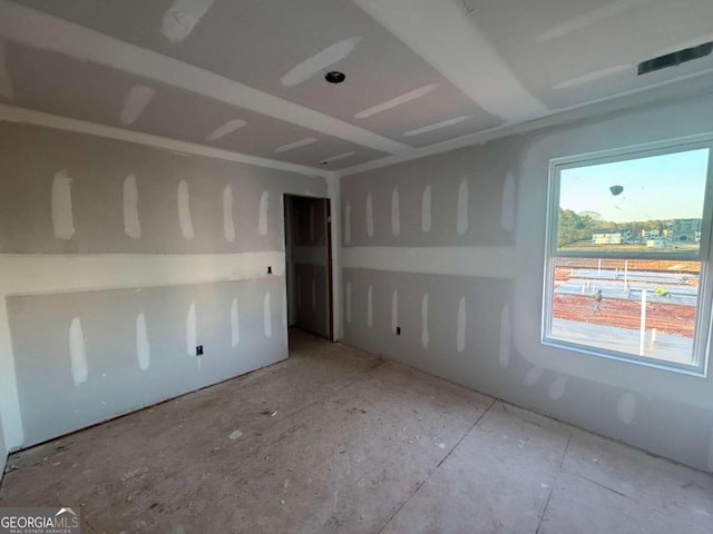 unfurnished room with visible vents