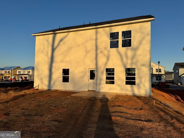 back of house featuring a residential view and a patio area