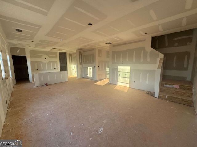 unfurnished living room with visible vents