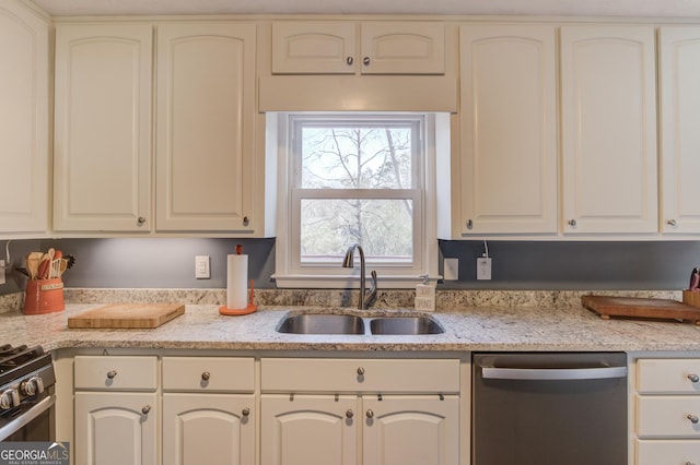 kitchen with stainless steel appliances, a sink, and light stone countertops