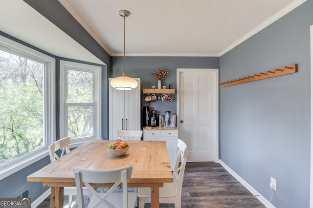 dining space featuring visible vents, baseboards, dark wood-type flooring, and crown molding