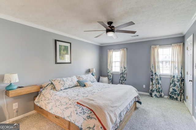 bedroom featuring a textured ceiling, visible vents, baseboards, carpet, and crown molding