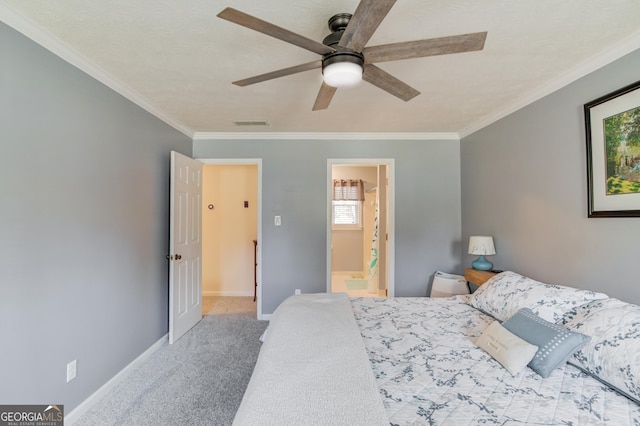 carpeted bedroom with ceiling fan, ornamental molding, ensuite bathroom, and baseboards