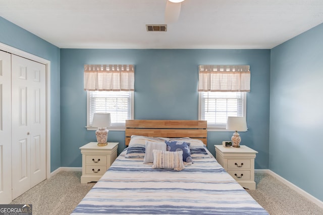 bedroom featuring carpet, a closet, visible vents, and baseboards