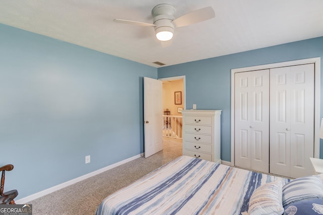 carpeted bedroom featuring visible vents, baseboards, and a closet