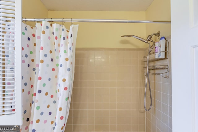 bathroom with tiled shower