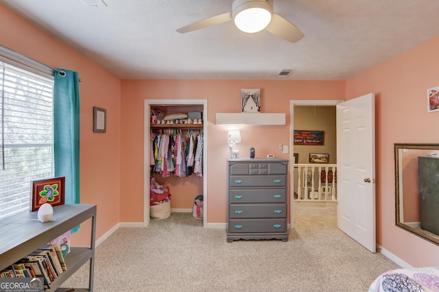 bedroom featuring carpet, a closet, visible vents, ceiling fan, and baseboards