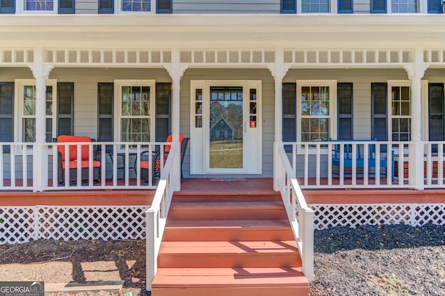 view of exterior entry with covered porch