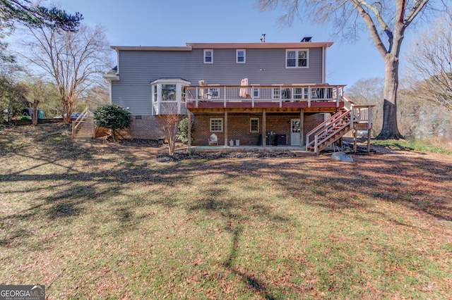 rear view of property featuring brick siding, central air condition unit, a lawn, stairway, and a wooden deck