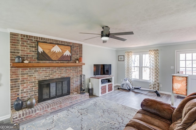 living area featuring ornamental molding, a brick fireplace, wood finished floors, and a wealth of natural light