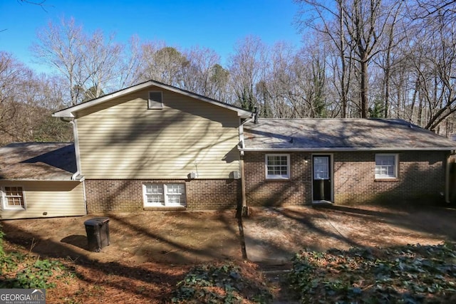 rear view of property featuring brick siding