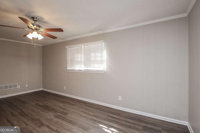 empty room with baseboards, visible vents, a ceiling fan, ornamental molding, and dark wood-style flooring