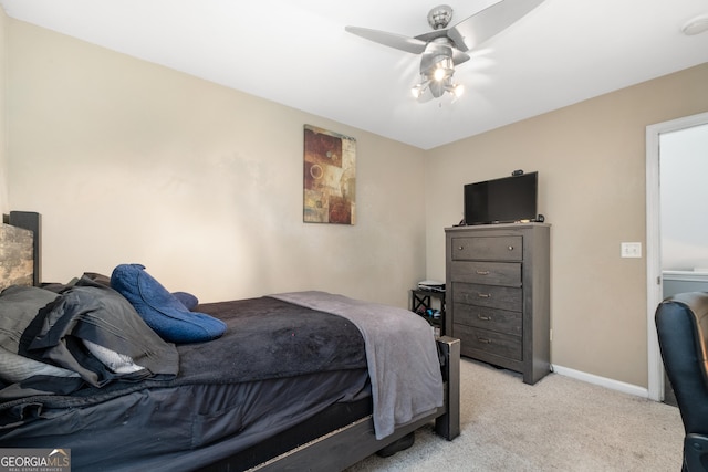 bedroom with a ceiling fan, light carpet, and baseboards