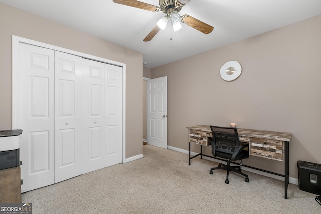 home office featuring light carpet, a ceiling fan, and baseboards