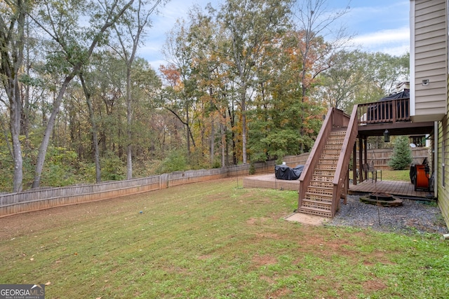 view of yard with stairs, a fenced backyard, and a wooden deck