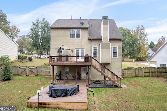 rear view of house with a fenced backyard, stairs, a wooden deck, a gate, and a chimney