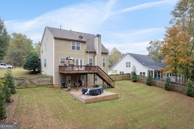 rear view of property with a fenced backyard, a chimney, stairs, a gate, and a deck