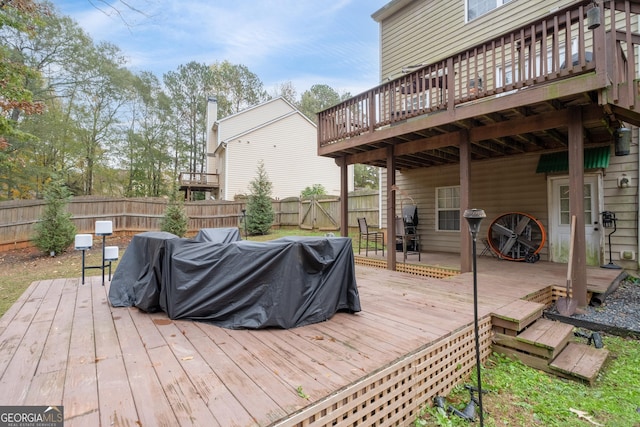 wooden deck featuring a fenced backyard