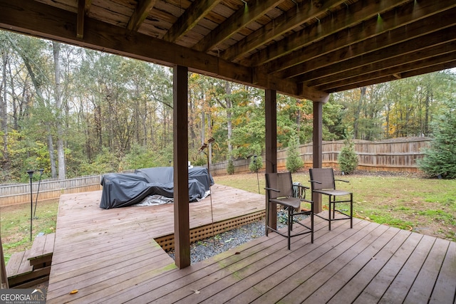 wooden deck with a fenced backyard, a lawn, and grilling area