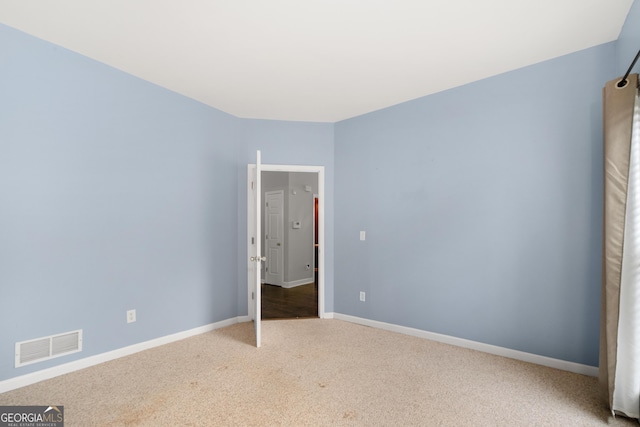 unfurnished bedroom featuring baseboards, visible vents, and carpet flooring