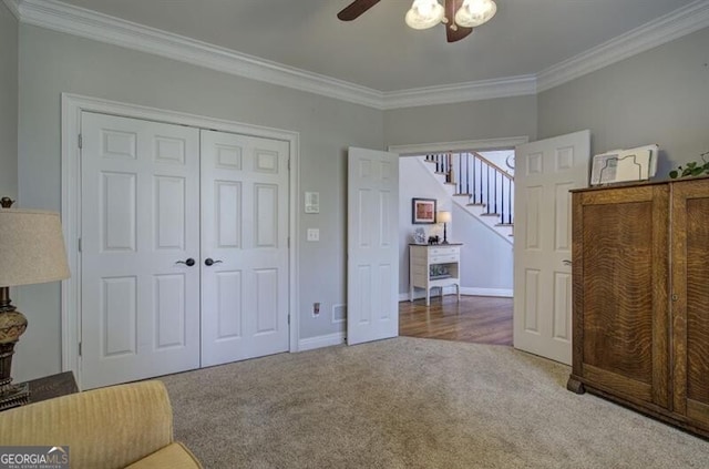 unfurnished bedroom featuring ornamental molding, a closet, and carpet flooring