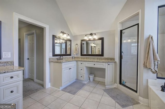 bathroom featuring lofted ceiling, a stall shower, a garden tub, and tile patterned floors