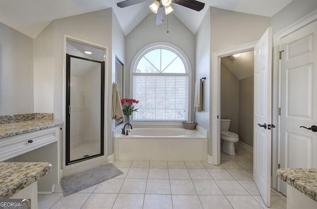 bathroom featuring a stall shower, toilet, lofted ceiling, a garden tub, and tile patterned flooring