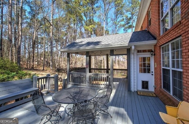 wooden terrace featuring outdoor dining area
