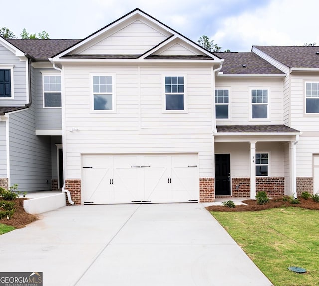 34 Russet Way Lot 57, Newnan, GA 30263 - view of front of home featuring brick siding, a garage, driveway, a front lawn, and roof with shingles