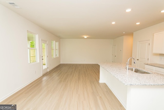 34 Russet Way Lot 57, Newnan, GA 30263 - kitchen with a sink, light wood-type flooring, white cabinetry, recessed lighting, and baseboards