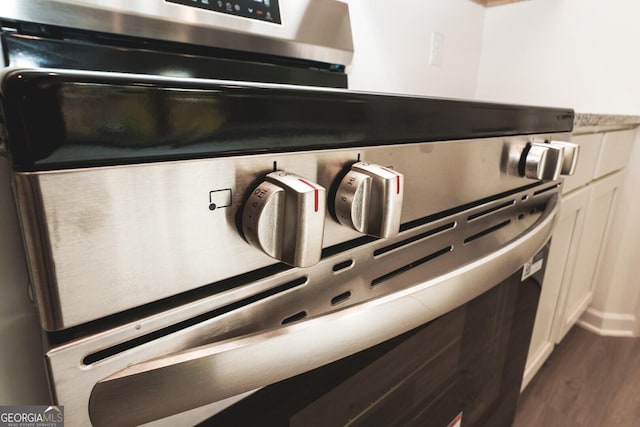 34 Russet Way Lot 57, Newnan, GA 30263 - kitchen view of stainless steel range with electric stovetop, dark wood-type flooring, and white cabinets