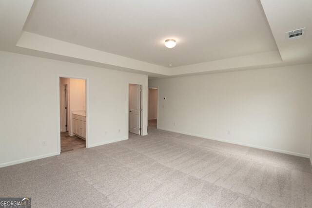 34 Russet Way Lot 57, Newnan, GA 30263 - unfurnished bedroom featuring a tray ceiling, baseboards, and light colored carpet