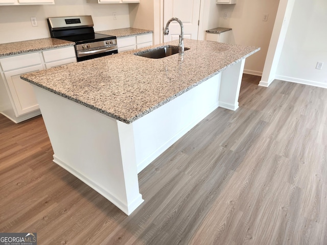 34 Russet Way Lot 57, Newnan, GA 30263 - kitchen featuring electric stove, a sink, white cabinetry, and light wood finished floors