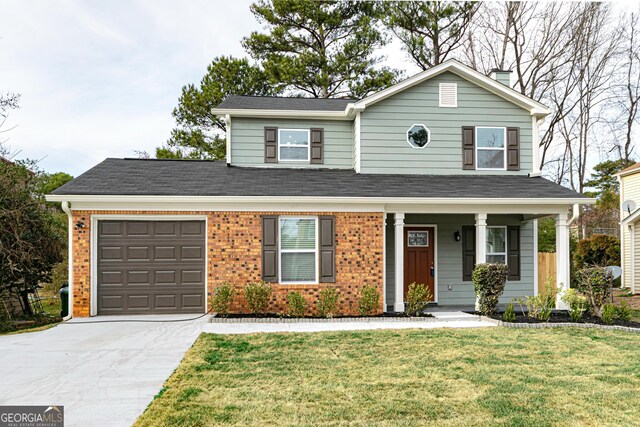 traditional-style house with an attached garage, brick siding, fence, concrete driveway, and a front yard