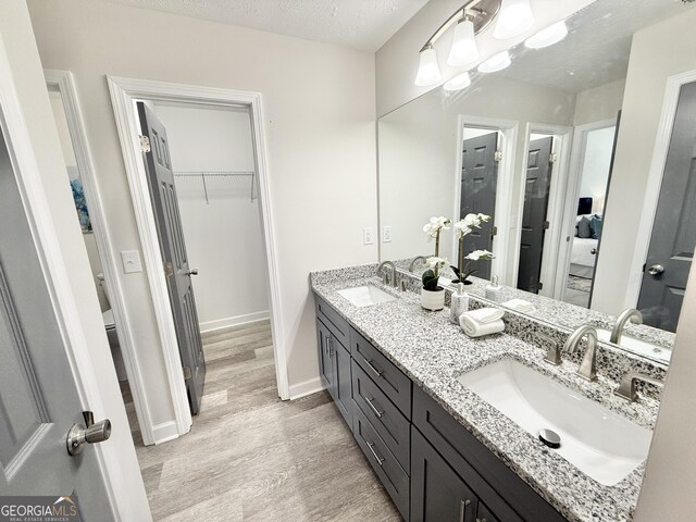 full bathroom featuring a textured ceiling and tiled shower