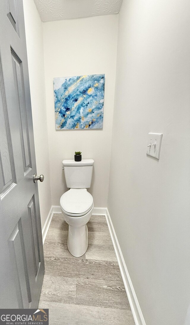 office area featuring light wood-style floors, ceiling fan, and baseboards