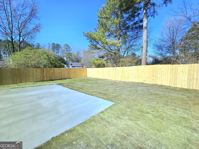 view of yard featuring a patio and a fenced backyard